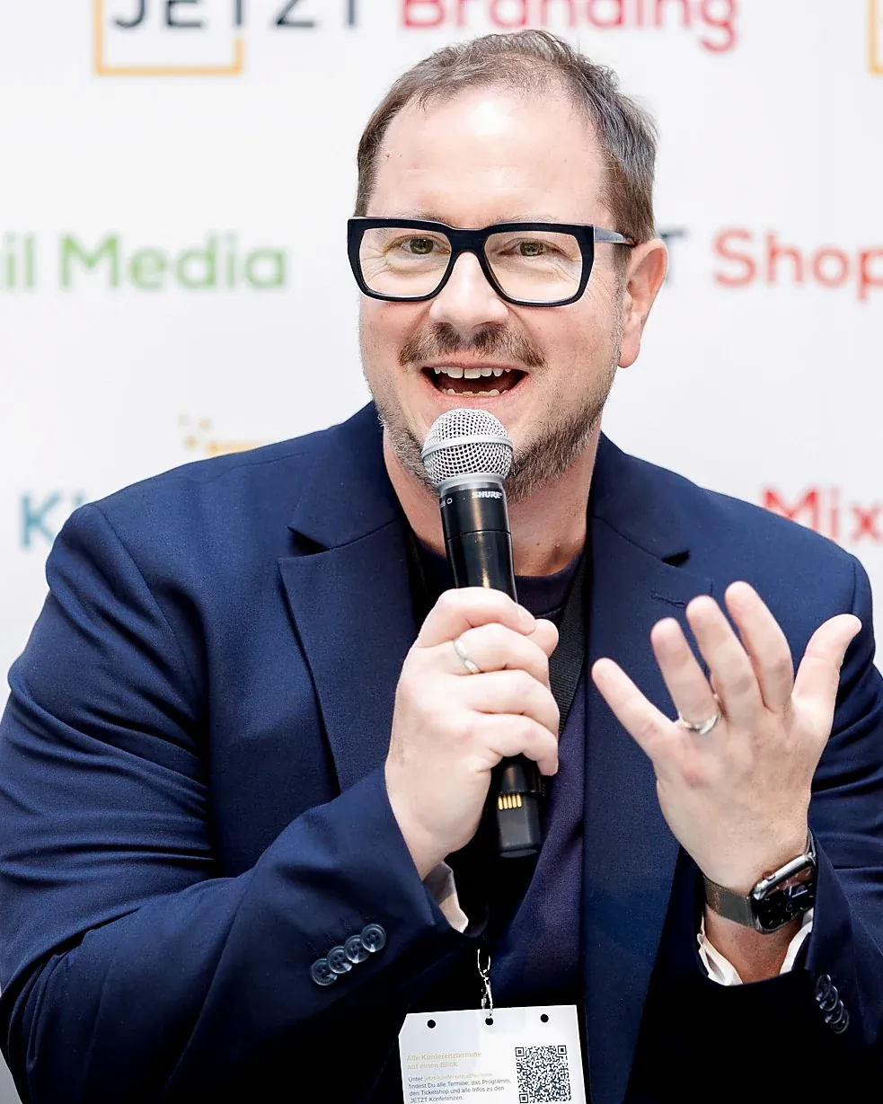 Close-up of Armin Rogl speaking on stage