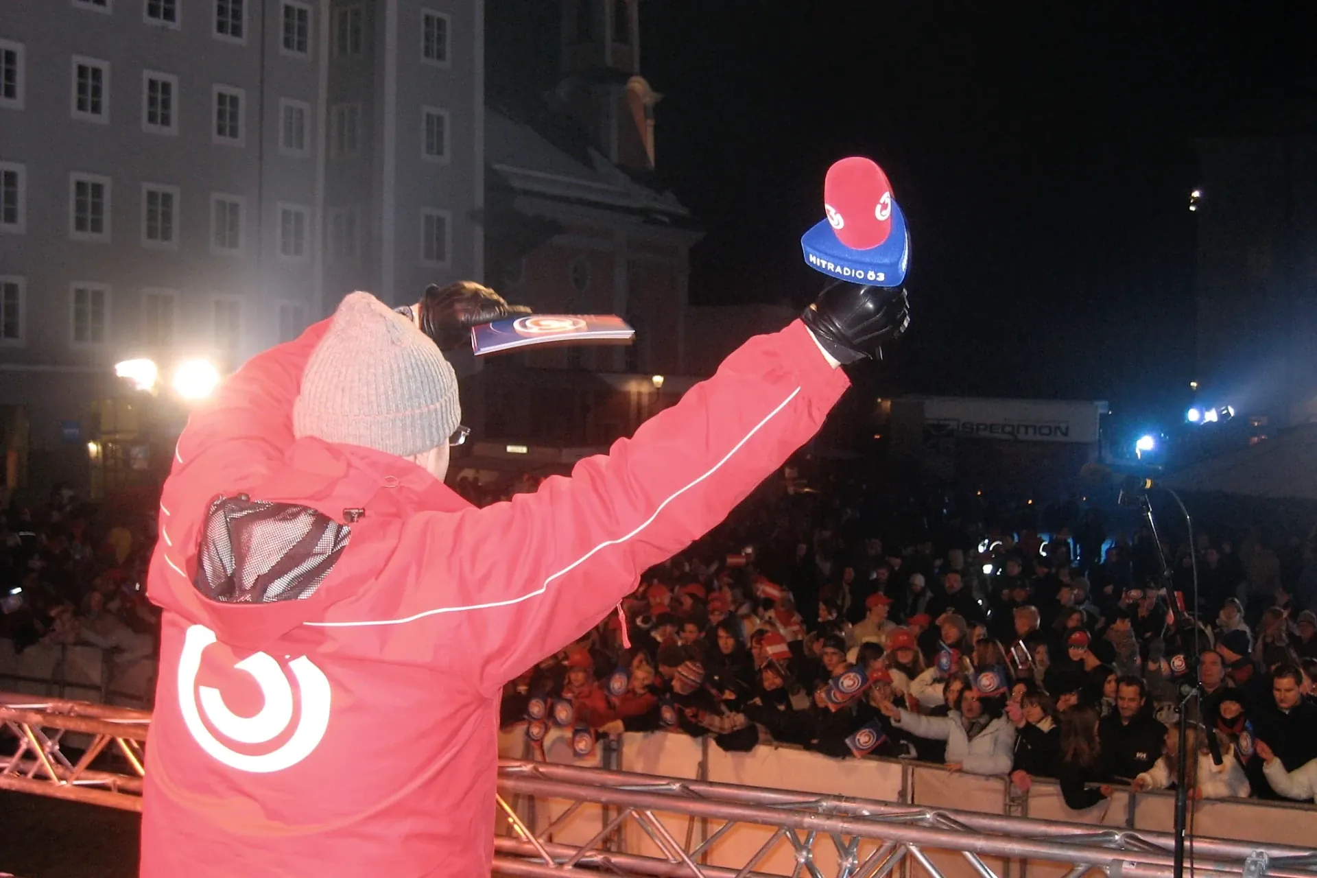 Armin Rogl on an outdoor stage at night in front of a large crowd