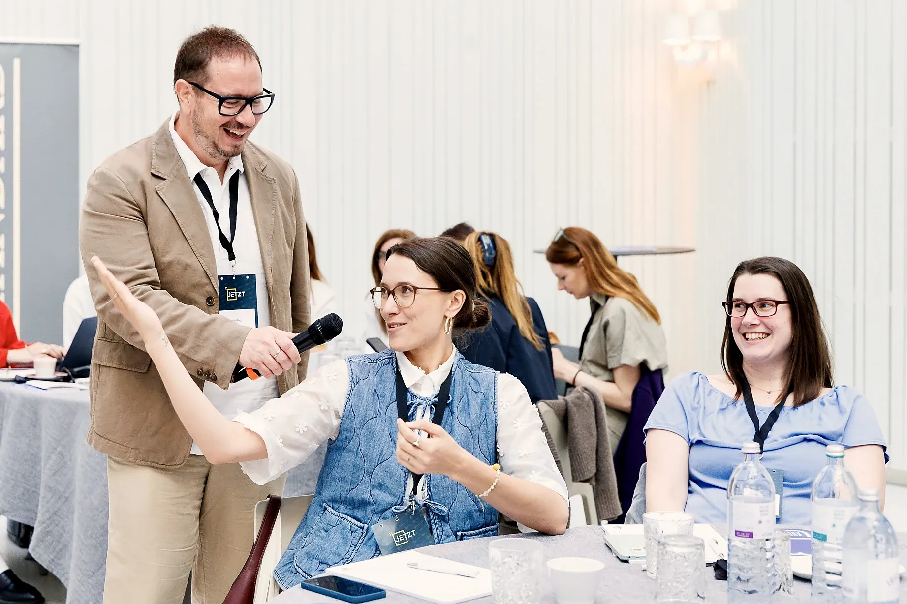Armin Rogl laughing while talking with people